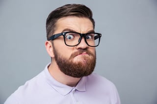 Portrait of a funny hipster man looking at camera over gray background-1.jpeg