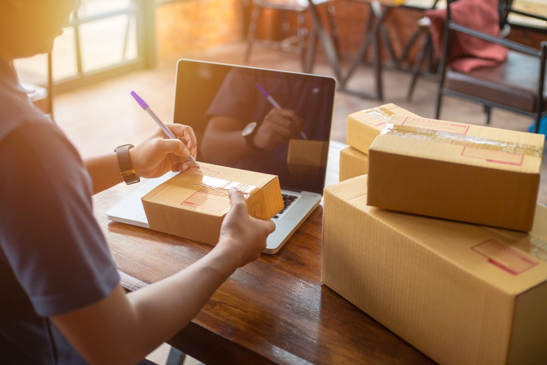 Worker preparing deliveries at computer