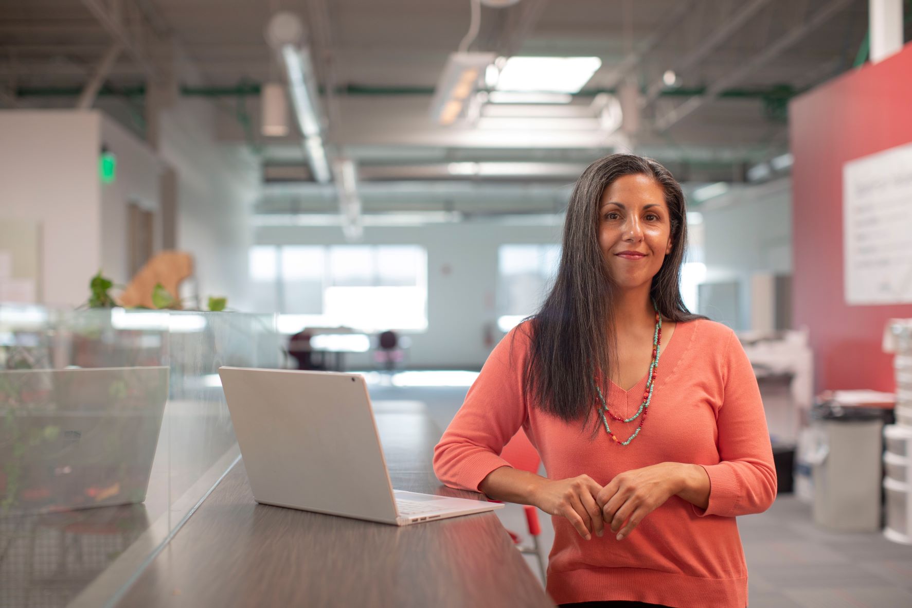 Woman with laptop in warehouse by Linkedin Sales Navigator